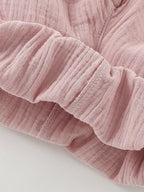 Close-up of a pink textured fabric on a light gray background