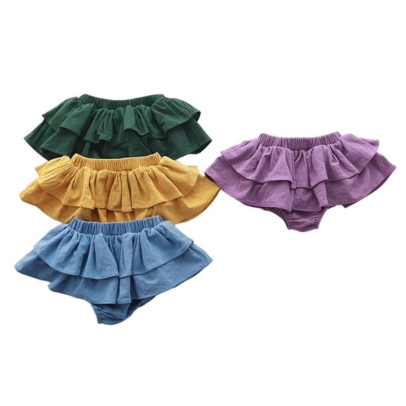 Four colorful ruffled bloomers on a white background