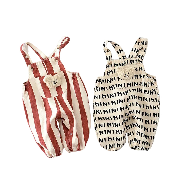 Two children's overalls, one striped and one with text pattern, on a white background