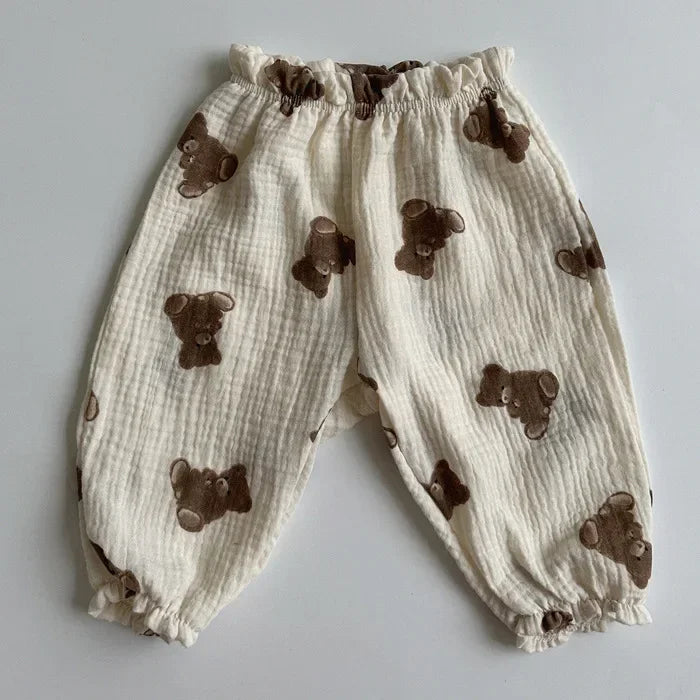 Baby pants with brown bear appliqués on a light gray background