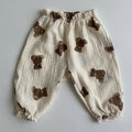 Baby pants with brown bear appliqués on a light gray background