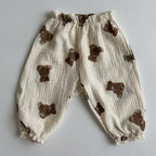 Baby pants with brown bear appliqués on a light gray background