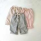 Three pairs of striped pants in different colors on a white background