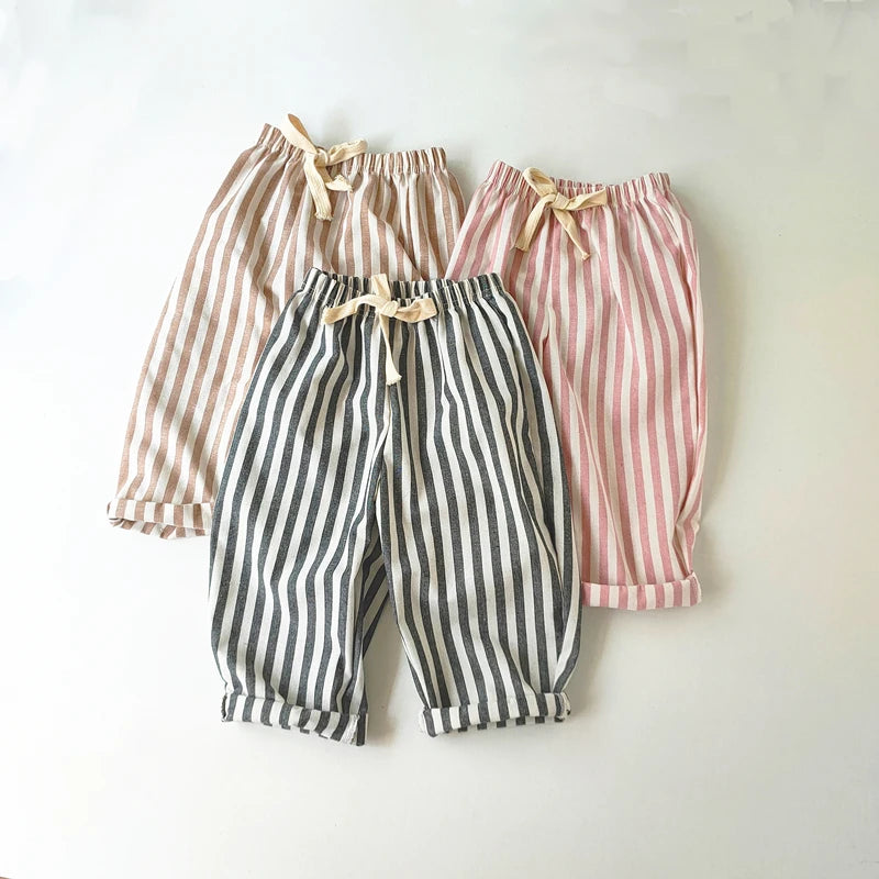 Three pairs of striped pants in different colors on a white background