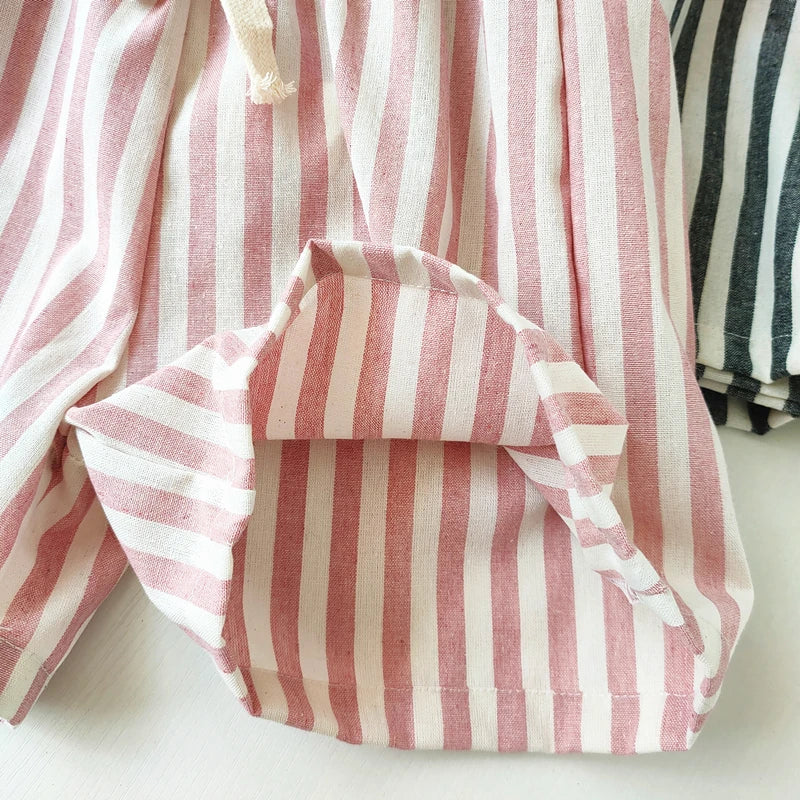 Pink and white striped fabric on a white background